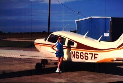 Barb standing by airplane